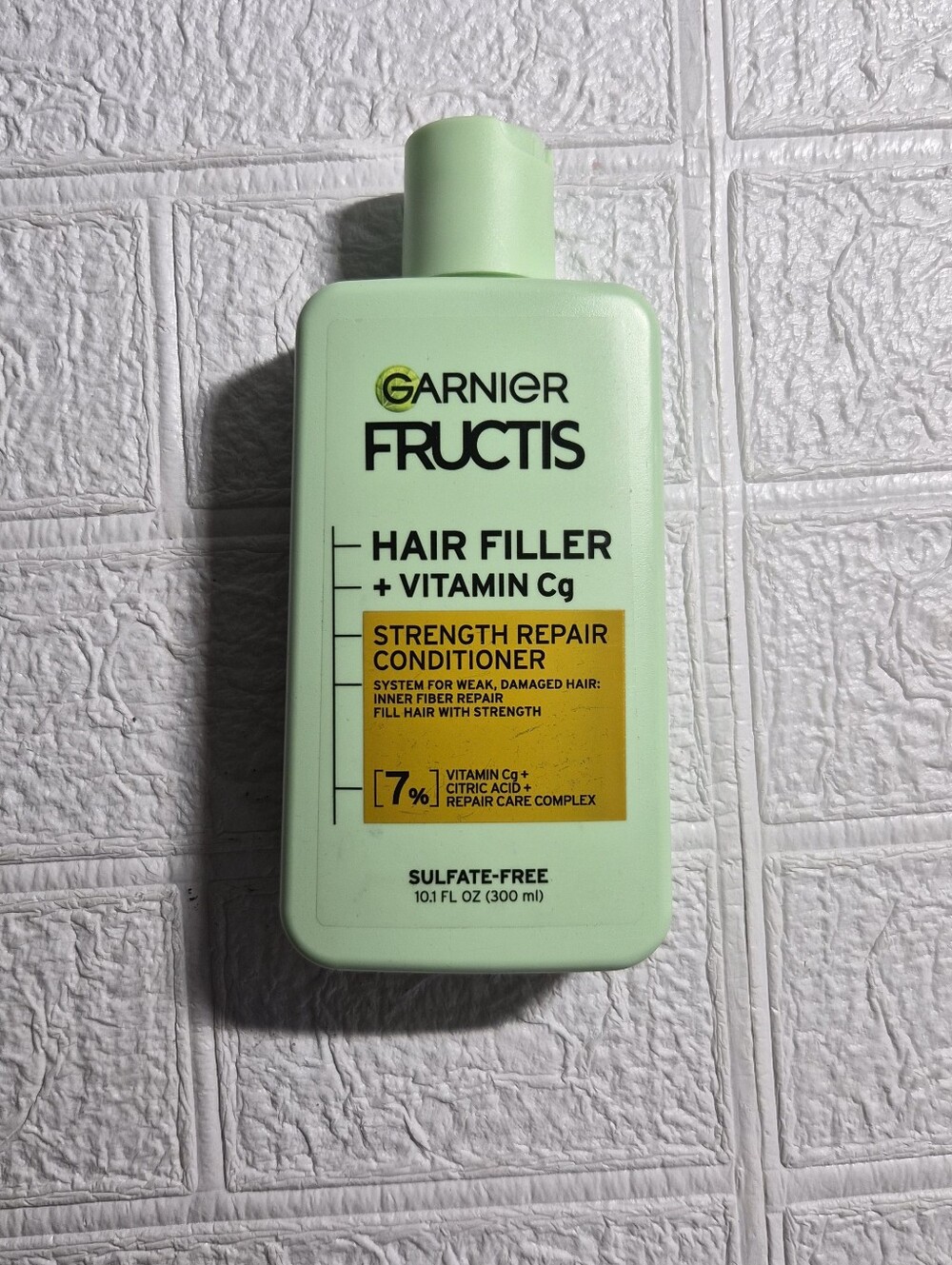 10.1 fl oz bottle of Garnier Fructis Hair Filler Strength Repair Conditioner,